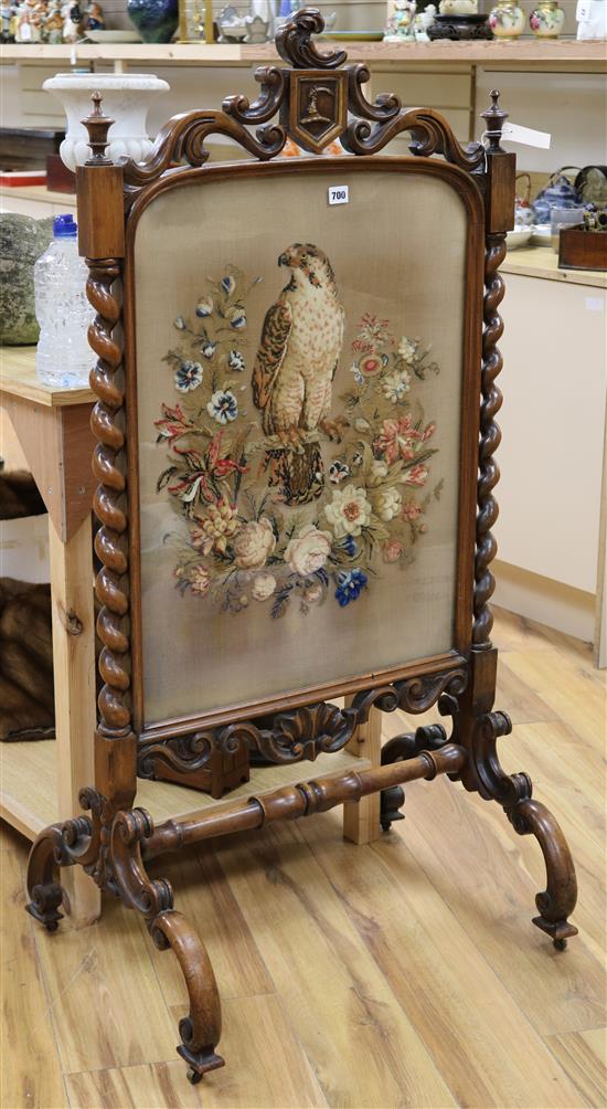 A Victorian carved walnut firescreen with needlework panel of a falcon W.68cm H.133cm